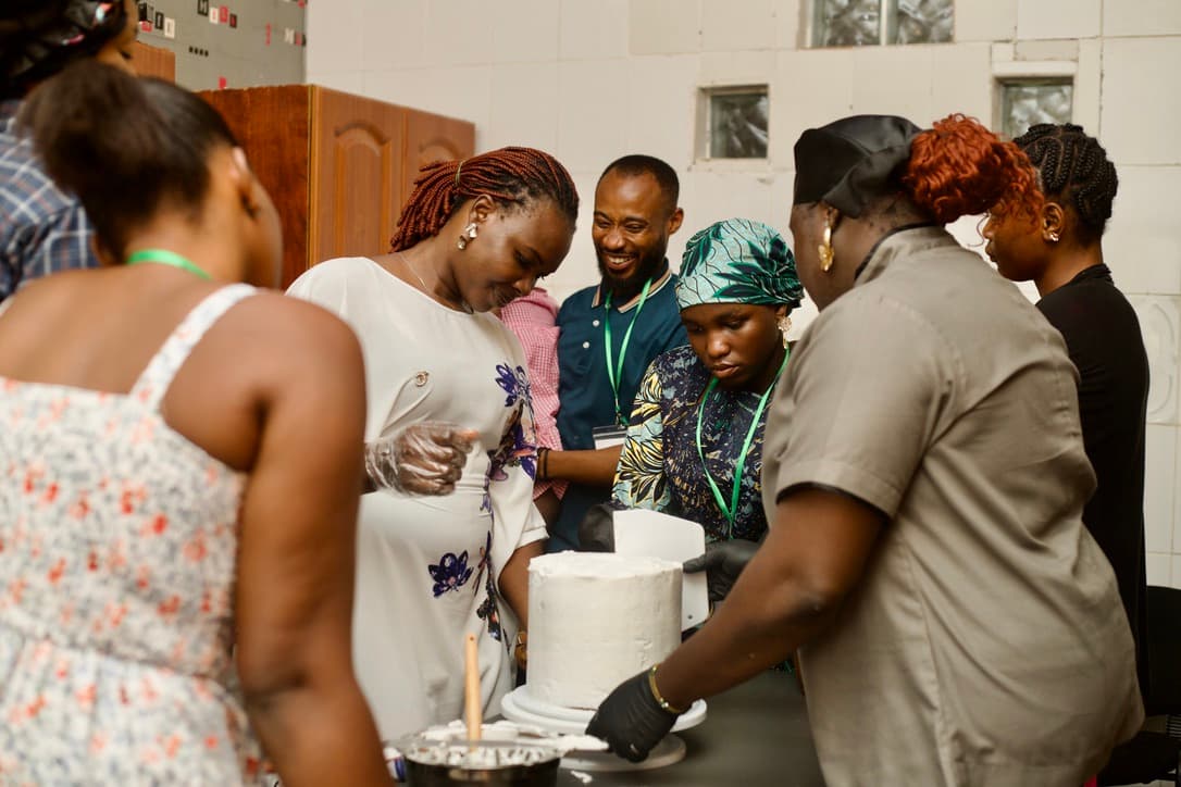 Participants learning cake decorating during a CNF skills workshop
