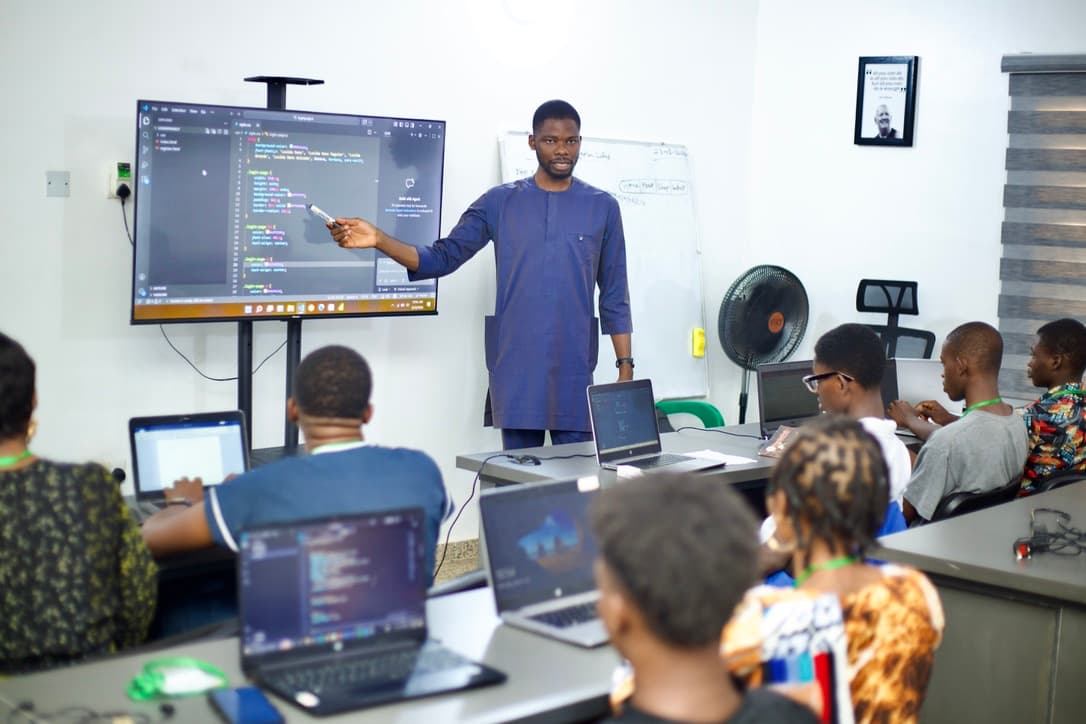 CNF Skill Scale-Up classroom training with instructor and students coding on laptops